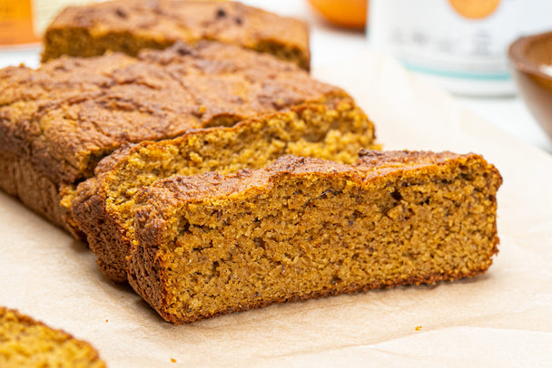 A loaf of pumpkin bread cut into thick slices.