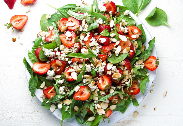 A heaping plate of spinach strawberry salad. 