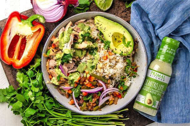 Overhead shot of burrito bowl, bottle of 