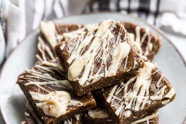 A plate of maple pecan collagen bars drizzled with white icing. 