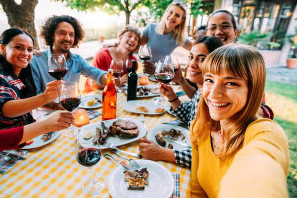 A group of friends taking a selfie at a picnic.