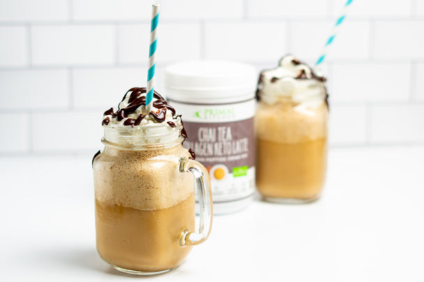 Chai Frappuccinos in mason jars with straws next to Primal Kitchen Chai Collagen Keto Latte Drink Mix 