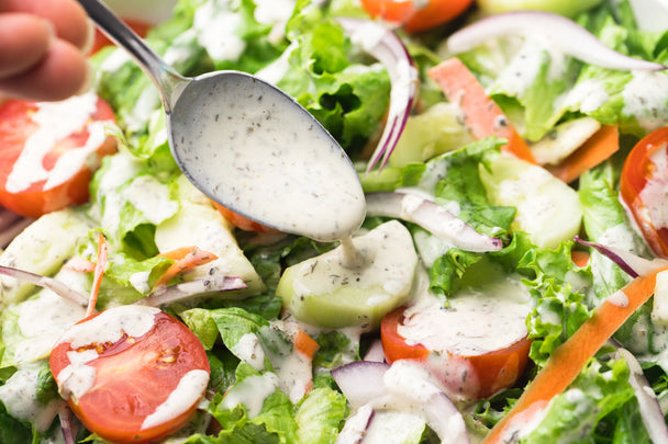 A garden salad drizzled in Primal Kitchen Ranch Dressing