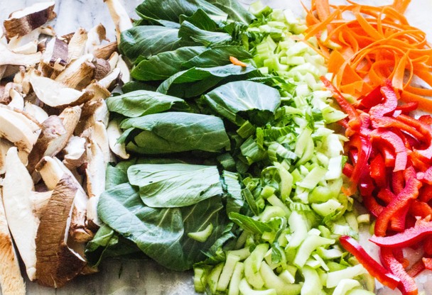 A plate of chopped veggies is arranged in color order.