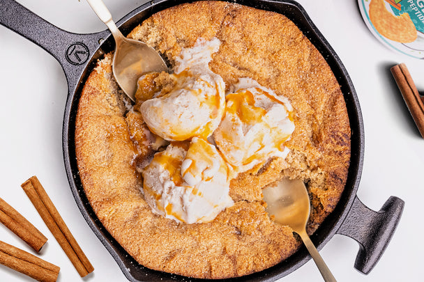 Snickerdoodle Skillet dish topped with vanilla ice cream & 2 spoons