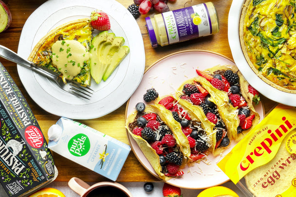 a spread of berry crepes, eggs benedict quiche, and all the ingredients used to make these dishes.