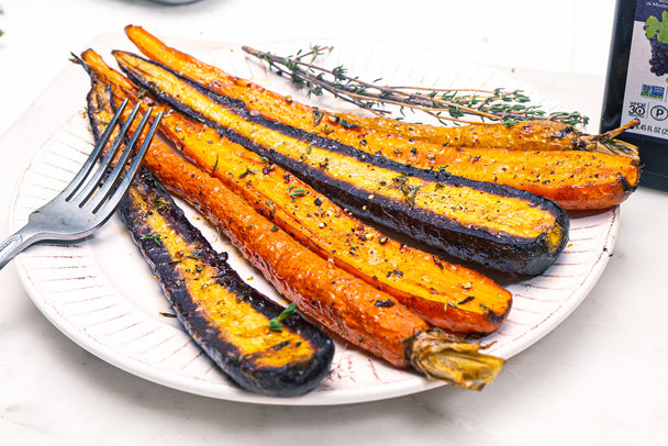 Roasted carrots with balsamic vinegar on a white plate