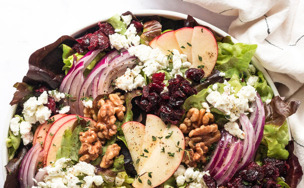 Closeup on a plate of apple walnut salad made with Primal Kitchen Balsamic Dressing and Marinade