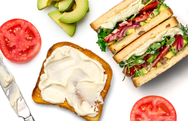 Veggie Sandwich stacked next to slice of toast with mayo