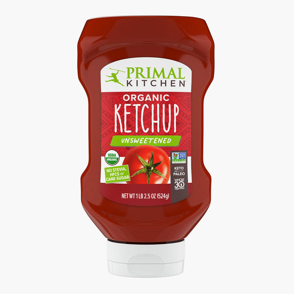 A Squeeze Bottle of Primal Kitchen Unsweetened Ketchup with No Added Sugar with a red label on a light grey background.