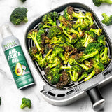 Primal Kitchen Air Fryer Spray Oil with an air fryer basket full of broccoli.