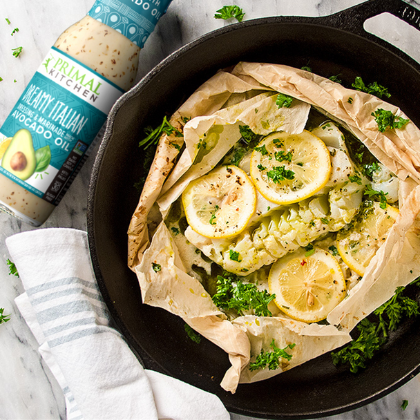 Baked fish in a cast iron skillet, marinaded in Primal Kitchen Dreamy Italian Dressing & Marinade made with Avocado Oil